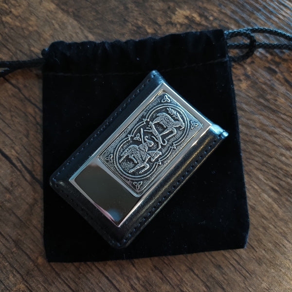 A leather money clip embellished with a horse motif from early  Irish art