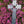 Load image into Gallery viewer, A handcrafted Mullingar Pewter Cross wall hanging with intricicate celtic knot work and resting on a bed of bright pink heather.