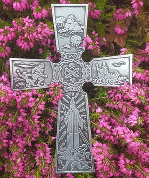 St. Patricks Cross wall hanging. Depicting the life of St. Patrick . Resting on a bed of purple heather