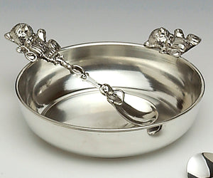 A PORRINDGER SIZE DISH AND SPOON WITH TEDDY DESIGN. APERFECT GIFT/ MOMENTO FOR ANY LITTLE BABY. PEWTER DISH AND PEWTER SPOON WITH TETTY BEAR DESIGN. PEWTER METAL SILVER FINISH MADE IN IRELAND