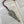 Load image into Gallery viewer, REPLICA OF SAMEUL BECKETT AS A BOOKMARK WITH PURPLE TOSSEL ATTACHED. MADE OF PEWTER METAL IN SILVER FINISH IRELAND.