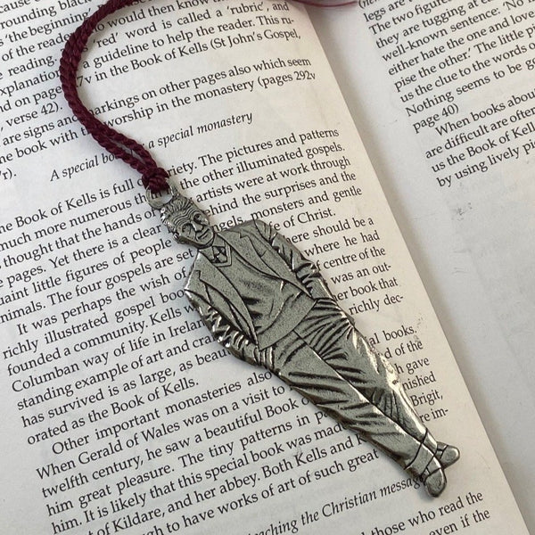 REPLICA OF SAMEUL BECKETT AS A BOOKMARK WITH PURPLE TOSSEL ATTACHED. MADE OF PEWTER METAL IN SILVER FINISH IRELAND.