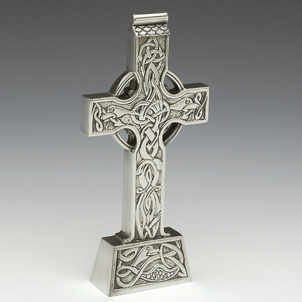 Celtic standing Cross is a replica of the Clonard High Cross that bonce stood in Clonard Co. Meath Ireland. The cross is 7" tall and is typical of Crosses around Ireland in shape and style. the cross has Celtic knotwork through out and has Dragon like creatures on its base and arms. This  cross is made in Ireland, by Mullingar Pewter