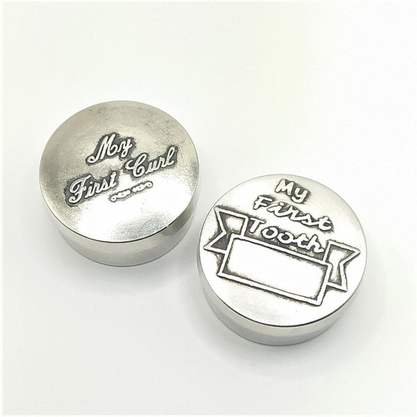 Pewter baby keepsake circular boxes. Great to look back at these little boxes of joy. How life evolves and how quick time passes these two preciously boxed item can evoke so many memories. each box is 1 1/2" wide and 1/2" deep. Polished pewter/silver finished boxes.