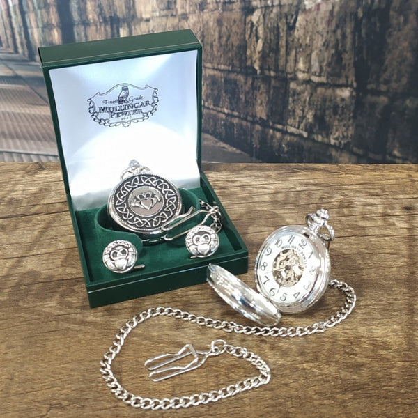 Mullingar Pewter Closed Mechanical Pocket watch and cufflink set decorated with Claddagh and celtic knots. An open Mechanical watch sits in front and are presented in front of a green presentation box.