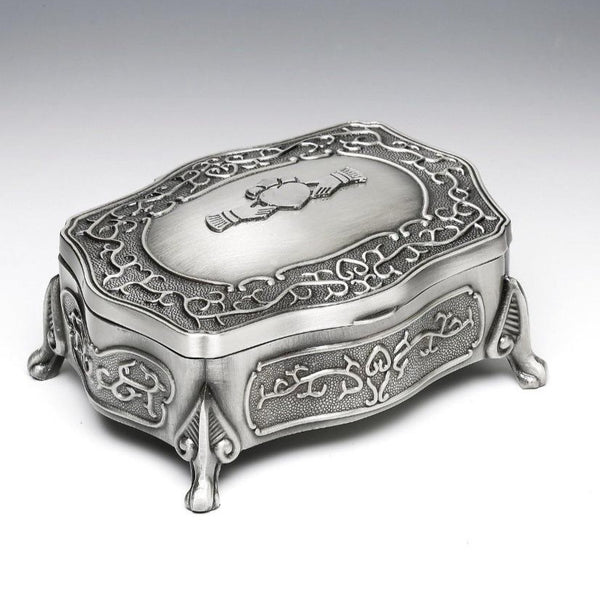 CLADDAGH JEWELLERY BOX WITH CELTIC SCROLL AND DELICATELY APPOINTED LEGS. The Pewter claddagh is fixed to the top of the box.