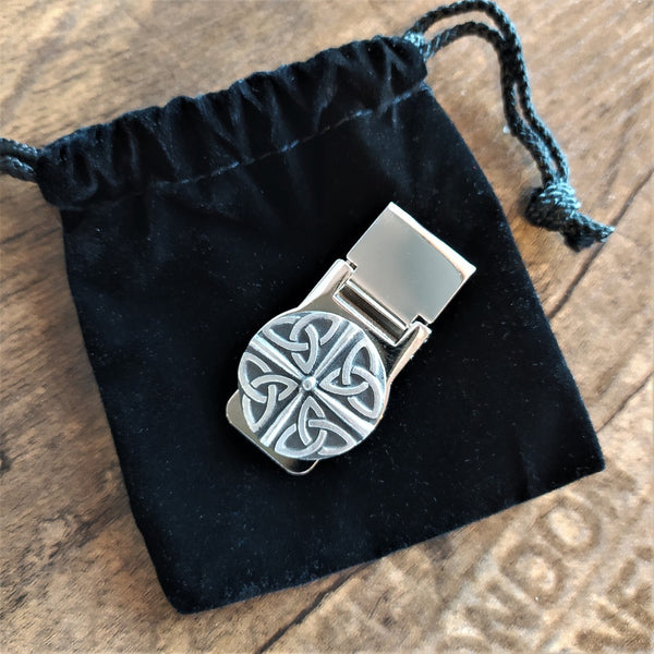 The T4 Money Clip by Mullingar Pewter sitting on a black velvet bag.