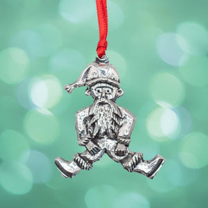 A silver colour Christmas Tree ornament of a leprechaun. Displayed on a red ribbon. 