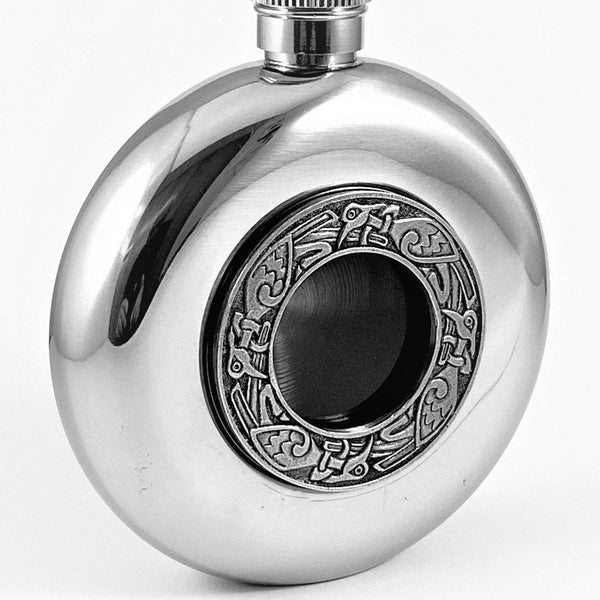 WHISKEY FLASK WITH CELTIC BIRD DESIGN AS IS SEEN IN OLD IRISH CELTIC MANUSCRIPT. THE FLASK IS 4" TALL AND HOLDS 5 FLUID OZS. THE POLISHED SILVERWARE FINISH AND PEWTER CELTIC DECORATION BLEND WELL TOGETHER. MADE IN IRELAND BY MULLINGAR PEWTER.