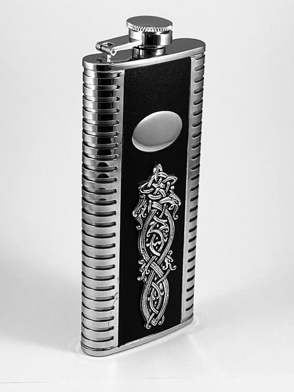 SLIMLINE HIP FLASK WITH LEATHER STRIP AND CELTIC DESIGN. ENGRAVABLE Pewter silver finish Celtic entwined dragons heads with engraving plate. 5 oz capacity and 6" tall.