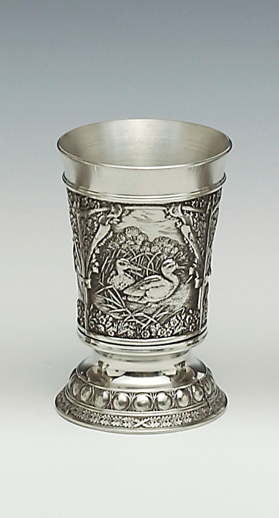 WOODLANDS PEWTER BEAKER WITH WILDE DUCK SCENES . THE BEAKER IS 5 1/2 " TALL AND HOLDS 12 FLUID OZS OF YOUR FAVOURATE BEVERAGE. THE PEWTER BEAKER HAS POLISHED SILVER FINISH TO THE TOP RIM AND LOWER BASE.