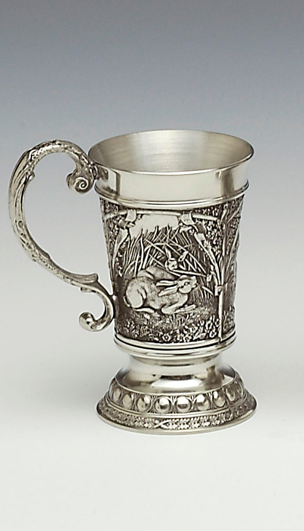THE MEASURE IS MADE OF CAST PEWTER. THE DECORATION IS OF HARE IN WILDLIFE SCENES IN A WOODLAND SETTING. THE MEASURE IS 2" TALL AND HOLDS 1 FLUID OZ. HANDMADE IN IRELAND BY MULLINGAR PEWTER.