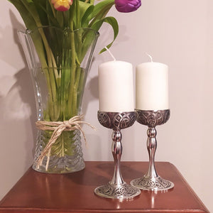 Beautiful hand crafted Candle holders set with white pillar candles. Ornate pattern of inspired by the Book of Kells Ireland . Silver colour made of pewter