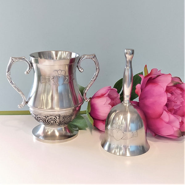 Beautiful silver colour mullingar pewter wedding acessories A couple drinking cup and a wedding bell both embossed with Claddagh motif