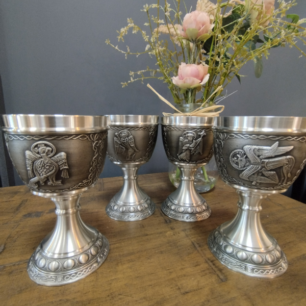 4 GOBLETS WITH THE 4 EVANGELISTS DEPICTED. ONE ON EACH AS IS SCEEN IN THE BOOK OF KELLS. ALL PEWTER METAL WITHSILVER SHEEN FINISH. Polished pewter base with Celtic knots and beading around the stem. 8oz capacity and 5 1/2" tall.