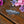 Load image into Gallery viewer, A silver-toned Celtic knotwork hair claw clip resting on a rustic wooden surface, styled with pink and purple flowers in the background.
