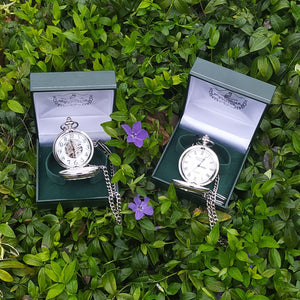 Mullingar Pewter Pocket watches resting on a bed of purple and green plants