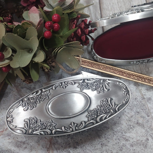 Mullingar Pewter oval shaped Jewellery box with flower motif and red velvet lining.