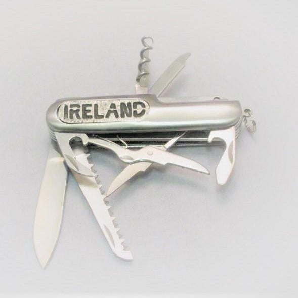 ARMY KNIFE MADE OF STAINLESS STEEL WITH MULTIABLE TOOLS ATTACHED. THE BLADE IS3" LONG AND THE CASE HAS THE WORD IRELAND ATTACHED.