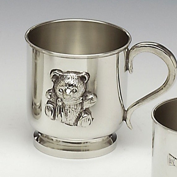 PEWTER BABY TEDDY CUP IDEAL FOR CHRISTENING AND ENGRAVES VERY WELL WITH PERSONALISED DETAILS, NAME, DATE ETC. THE CUP HOLDS ITS SILVER SHINE AS PEWTER METAL DOES. MADE IN IRELAND