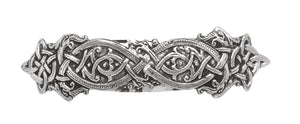 A HAIR BARRETTE WITH ENTWINED DRAGONS IN KELLS STYLE KNOTS. MADE OF PEWTER WITH CHROMED CLASP IN PEWTER/SILVER FINISH. MADE IN IRELAND