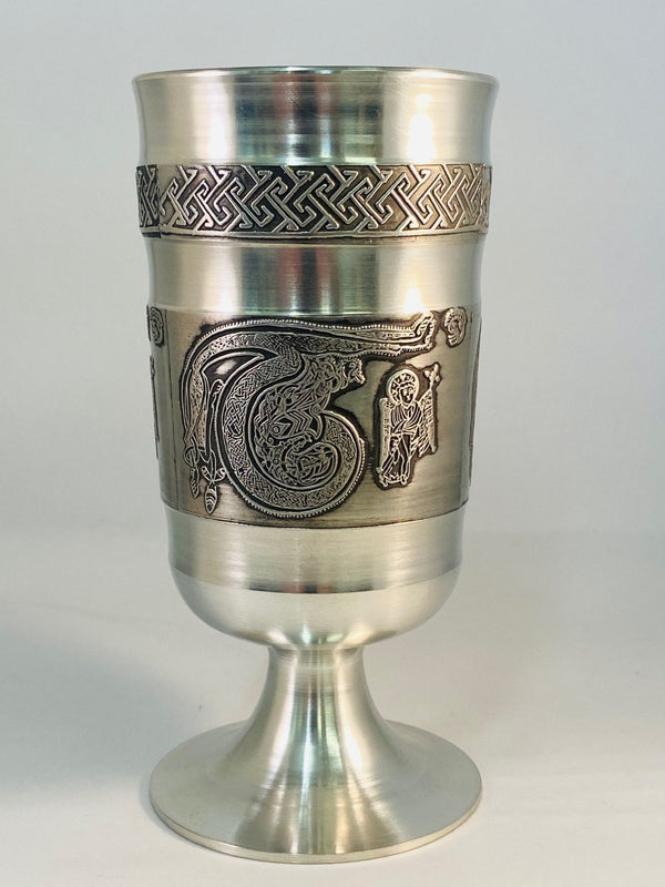 THE GOBLET IS HANDCAST IN PEWTER METAL WITH A LETTER DECORATION IN CELTIC DESIGN OF THE LETTER T WITH VERY DETAILED CELTIC DRAGON LIKE DESIGN AND A SAINTLY FIGURE OF MATHEW WITH CELTIC PATTERN ABOVE. THE BASE IS FINISHED IN SOFT SILVER FINISH AND HANDTURNED ON THE INSIDE OF THE GOBLET. ÉTAIN ZINN HARTZINN METAL PELTRO
