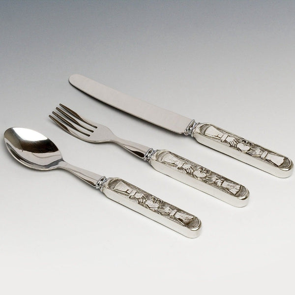 CLADDAGH BABY PEWTER STAINLESS STEEL KNIFE , FORK AND SPOON SET. THE HANDLES ARE PEWTER AND THE BLADES ARE STAINLESS. PEWTER SILVER FINISH MADE IN IRELAND