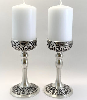 CANDLE HOLDER SET 4 1/2 " TALL CANDLE HOLDERS WITH WHITE CANDLES. COME IN PRESENTATION BOX  MADE OF PEWTER METAL WITH SOFT SILVER FINISH. THE DESIGN IS CELTIC AND IS INSPIRED BY ALL THE CELTIIC CROSSES FOUND IN IRELAND. EACH PIECE IS HAND CAST AND THEN HAND TURNED WITH GREAT ATTENTATION TO DETAIL ON ALL THE CELTIC DESIGN WITH POLISHED SILVERWARE FINISH.