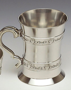 CLADDAGH STRIP TANKARD. THIS TANKARD HOLDS 18 FLUID OZS AND HAS A HEIGHT OF 5". THE DESIGN IS THAT OF THE CLADDAGH AND THE PIECE IS CAST PEWTER HAND MADE IN IRELAND