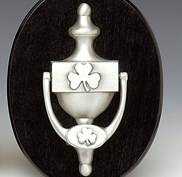 SHAMROCK DOOR KNOCKER MADE OF CAST PEWTER. THE DOOR KNOCKERS IS 7" LONG AND HAS A LARGE SHAMROCK EMBOSSED IN THE CANTRE AND A SMALLER SHAMROCK EMBOSSED ON THE KNOCKER ITSELF. THE DOOR KNOCKER IS 7" LONG AND IS HANDMADE IN IRELAND.