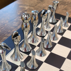 contemporary pewter chess set. made of pewter metal with dark and silver sides. All pewter pieces just plain and simple. Great house warming gift or Christmas gift.. board is 14" square.