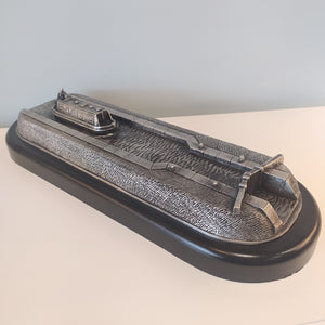 A sculpture made of Pewter which depicts a canal barge approaching a lock gate