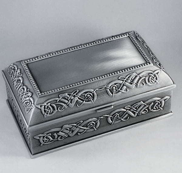 7" LONG CELTIC STYLE JEWELRY BOX THE BOX AND HINDGED LID ARE SURROUNDED WITH CELTIC KNOTWORK  AND THE LID HAS A BEADED AREA THAT ALLOWS FOR ENGRAVING THE CENTRE OF THE LID IS PLAIN FOR PERSONALIZING. THE BOX IS POLISHED TO A SOFT PEWTER SILVERWARE SHEEN WITH CONTRASTED BACKGROUND. GREAT GIFT FOR THE LOVE IN YOUR LIFE