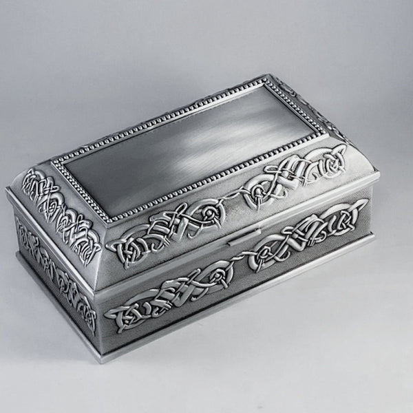 5" LONG CELTIC JEWLERY BOX WITH CELTIC DESIGN SURROUNDING THE BOX. THE LID IS BEADED WITH CELTIC SURROUND AND THE PLAIN CENTER BALLOWS FOR ENGRAVING. THE BOX IS POLISHED TO A SOFT PEWTER SILVERWARE SHEEN FINISH THAT IS CONTRASTED WITH A DARKER BACKGROUND. GREAT ENGAGEMENT GIFT.