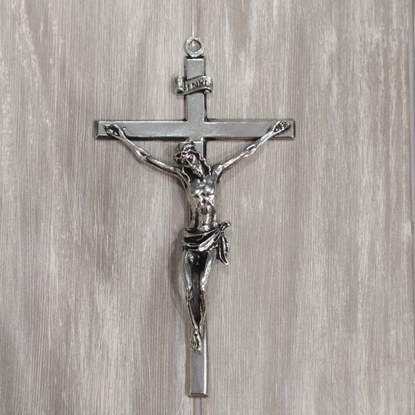 Medium size Crucifix of Christ hanging on the cross. Cross is made of Mullingar Pewter Silver in colour