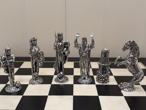 MYTHICAL IRISH CHESS SET. THIS CHESS SET TELLS THE STORY OF THE TUATHA DE DANANN A MYTHICAL IRISH RACE THAT EXISTED BEFORE THE DRUIDS. THEY WERE REVERED AS A MAGICAL RACE. THE CHESS BOARD IS 14" SQUARE IN SIZE AND THE PIECES ARE 3 1/2" TALL TO 2 1/2" TALL.. PEWTER PIECES AND A TIMBER BOARD.