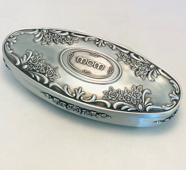 This ornate Oval shaped jewellery box with mom in the centre makes a great mothers day gift. The box is 7" long and lined on the inside with a velvet finish. pewter silverware polished soft sheen finish.