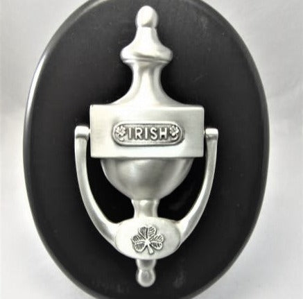 IRISH DOOR KNOCKER WITH THE WORD IRISH EMBOSSED ON THE CENTRE OF THE DOOR KNOCKER. THE KNOCKER ITSELF HAS A SMALL SHAMROCK EMBOSSED ON IT AND THE COMPLETE PIECE IS 7" LONG.