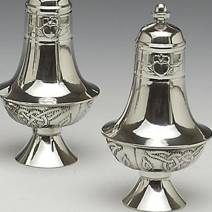 SALT AND PEPPER SET WITH CLADDAGH AND CELTIC DESIGN. STANDING ALMOST 5 1/2" HIGH THESE MAKE A LOVELT SET ON ANY TABLE. PEWTER SILVERWARE FINISH.
