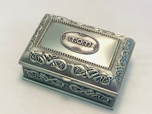 SMALL PEWTER JEWELLERY BOX WITH CELTIC DESIGN AND MOM ON THE LID. THE SOFT SILVER SHEEN IS LIGHT AND EASY ON THE EYE. THE BOX IS 3 1/2 " LONG, THE BOX IS POLISHED IN A PEWTER SILVERWARE FINISH AND MAKES A GREAT THANK YOU GIFT FOR ANY MOTHER