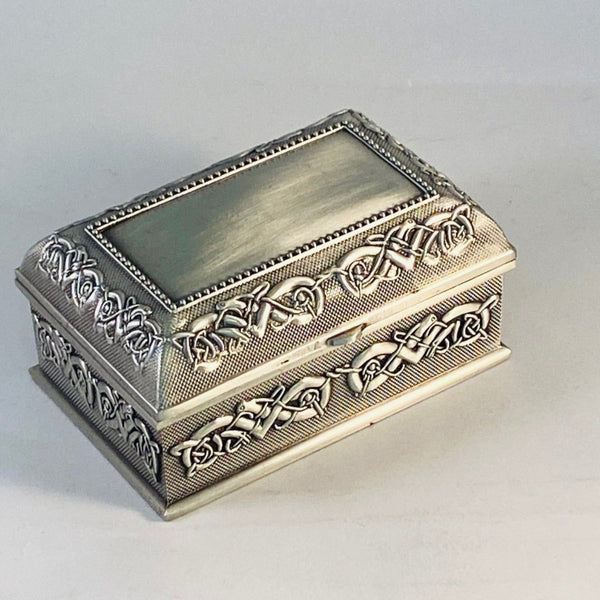 SMALL JEWELLERY BOX WITH PLAIN LID AND CELTIC PATTERN SURROUND. THIS LOVELY LITTLE RING BOX MAKES A PERFECT GIFT. CAN HOLD THOSE SPECIAL ITEMS AND SO EASY TO ENGRAVE. AVAILABLE WITH AND WITHOUT CLADDAGH WITH LOVELY CLETTIC DESIGN. PEWTER SILVERWARE METAL FINISH