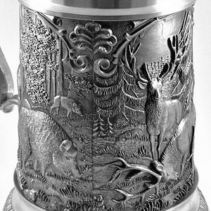 PEWTER WOODLANDS STEIN WITH WILDLIFE SCENES IN WOODLAND SETTINGS. THE STEIN STANDS AT 8" TALL AND HOLDS 25 FLUID OZS. THE FINISH IS  POLISHED AND BLACKENED AND THIS GIVES A GREAT CONTRAST. THE LID HAS ROOM FOR PERSONALIZED ENGRAVING.HANDMADE IN IRELAND BY MULLINGAR PEWTER