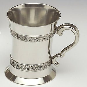 CELTIC STRIP TANKARD. The design is that of Celtic entwined knotwork. The tankard holds 18fluid ozs and stands 5" tall. Hand made in Ireland of Cast pewter the tankard is both elegant and sturdy.
