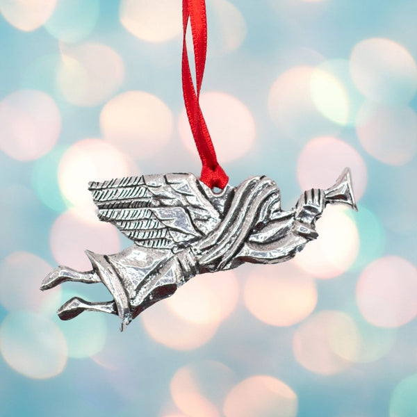 Angel Christmas tree ornament made from silver colour pewter metal and hanging on a red ribbon
