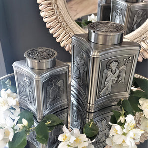Two different size pewter Urns designed to hold the ashes of a deceased loved one. Embossed with Book of Kells inspired motifs. 