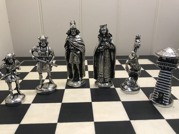 CHESS SET OF VIKING FIGURES. This set replicates the Viking s that invaded Ireland in the 8th and 9th centuries. the king stands at 3 3/4" high and the pawn is 2 1/2" tall. the board is 14" square.  Handmade in Ireland by Mullingar Pewter.