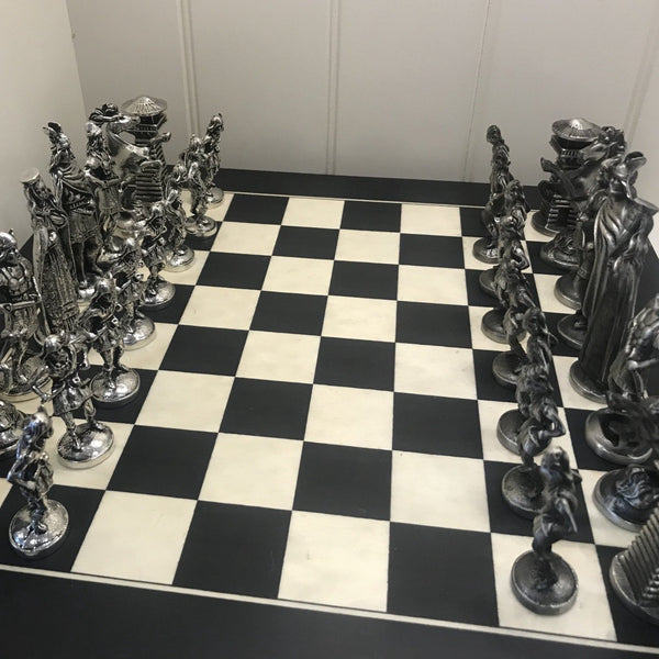 CHESS SET OF VIKING FIGURES. the vikings invaded Ireland during the 8th and 9th centuries and  were finally defeated in 1014 at the battle of Clontarf by Brian Boru, High King of Ireland. The king is 3 3/4" tall and the pawn is 2 1/2" tall. The board is 14" square. Handmade in Ireland, by Mullingar Pewter