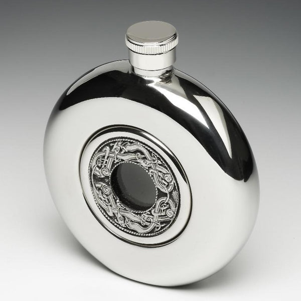 WHISKEY FLASK WITH KELLS DESIGN AROUND THE GLASS CENTER. THE FLASK IS 5 FLUID OZS AND STANDS 4" TALL. THE POLISHED FINISH GIVES A SILVERWARE LOOK. MADE IN IRELAND BY MULLINGAR PEWTER