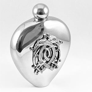 WHISKEY FLASK HEART SHAPE WITH CELTIC DRAGON. HANDMADE PEWTER METAL DESIGN WITHPOLISHED SILVER FINISH. PERFECT FOR MEN AND WOMEN AS WEDDING GIFTS. 6oz capacity makes this a very elegant and neat drinks flask.