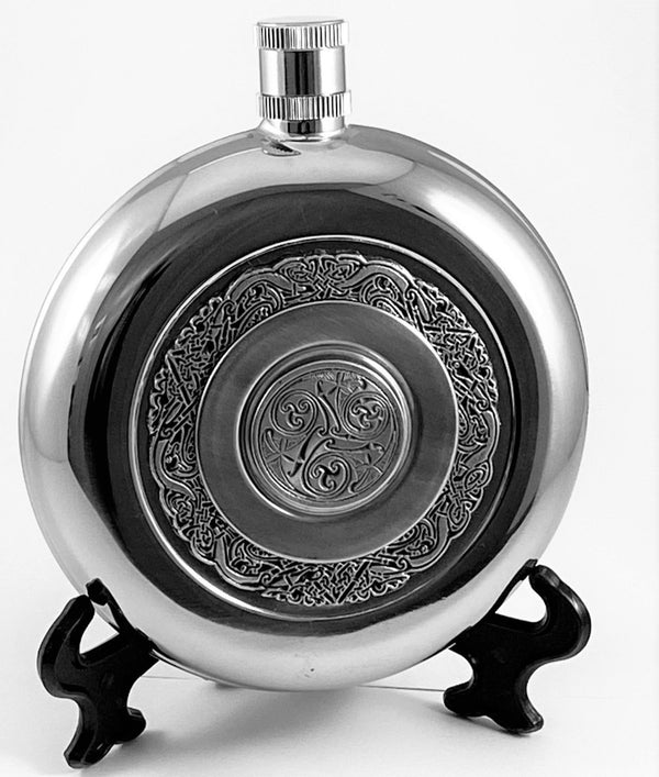 ROUND POCKET FLASK WITH CUP.  GRAET WHISKEY FLASK WITH THE ADDED ADDITION OF HAVING A DRINKING CUP ALL IN CELTIC DESIGN. PEWTER SILVERWARE STAINLESS STEEL . MADE IN IRELAND
